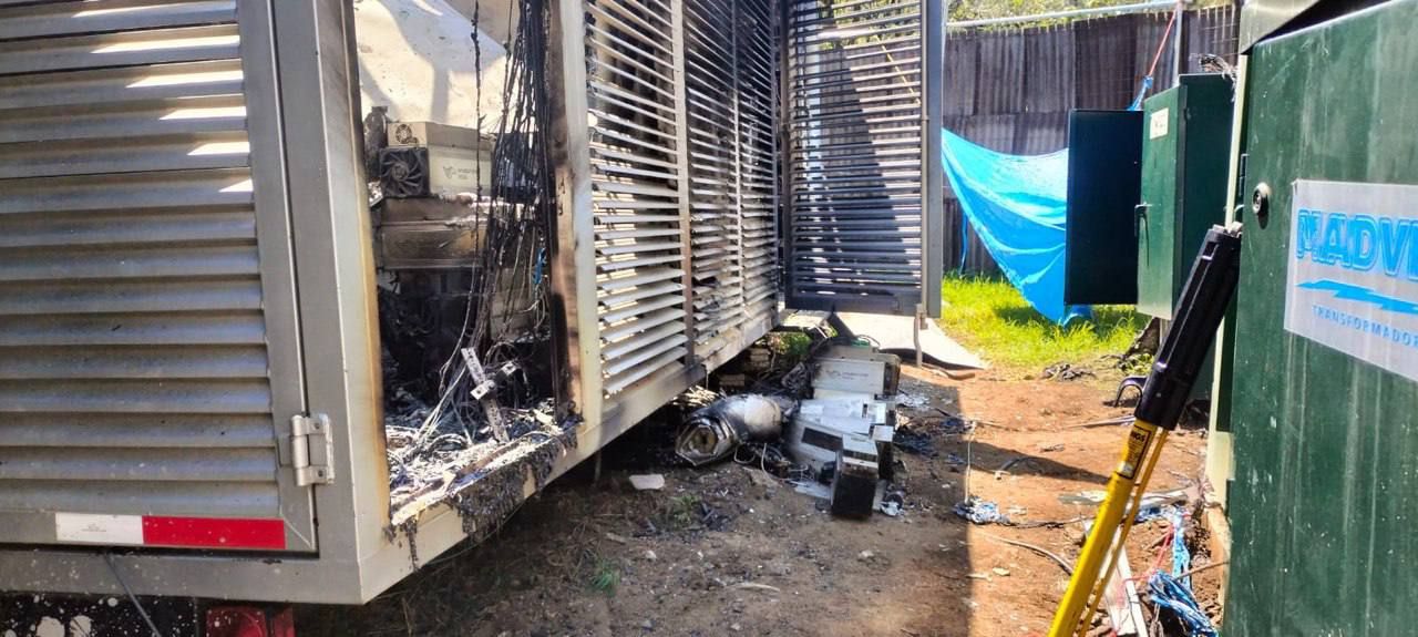 Outside of the burned mining container next to the transformers