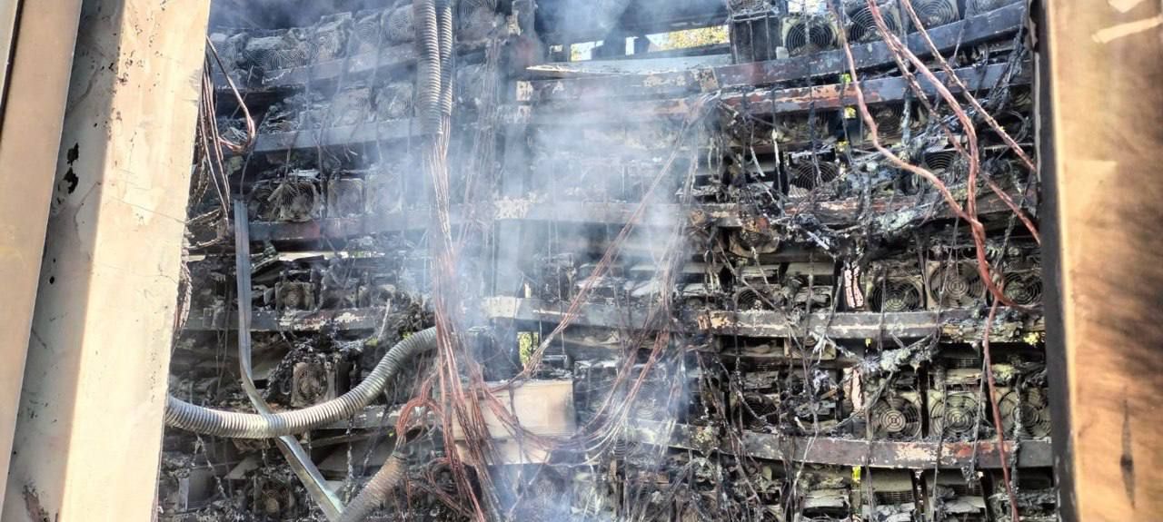 Smoke rising from burned racks of Bitcoin miners